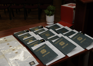Uz galda izkārtoti diplomi
